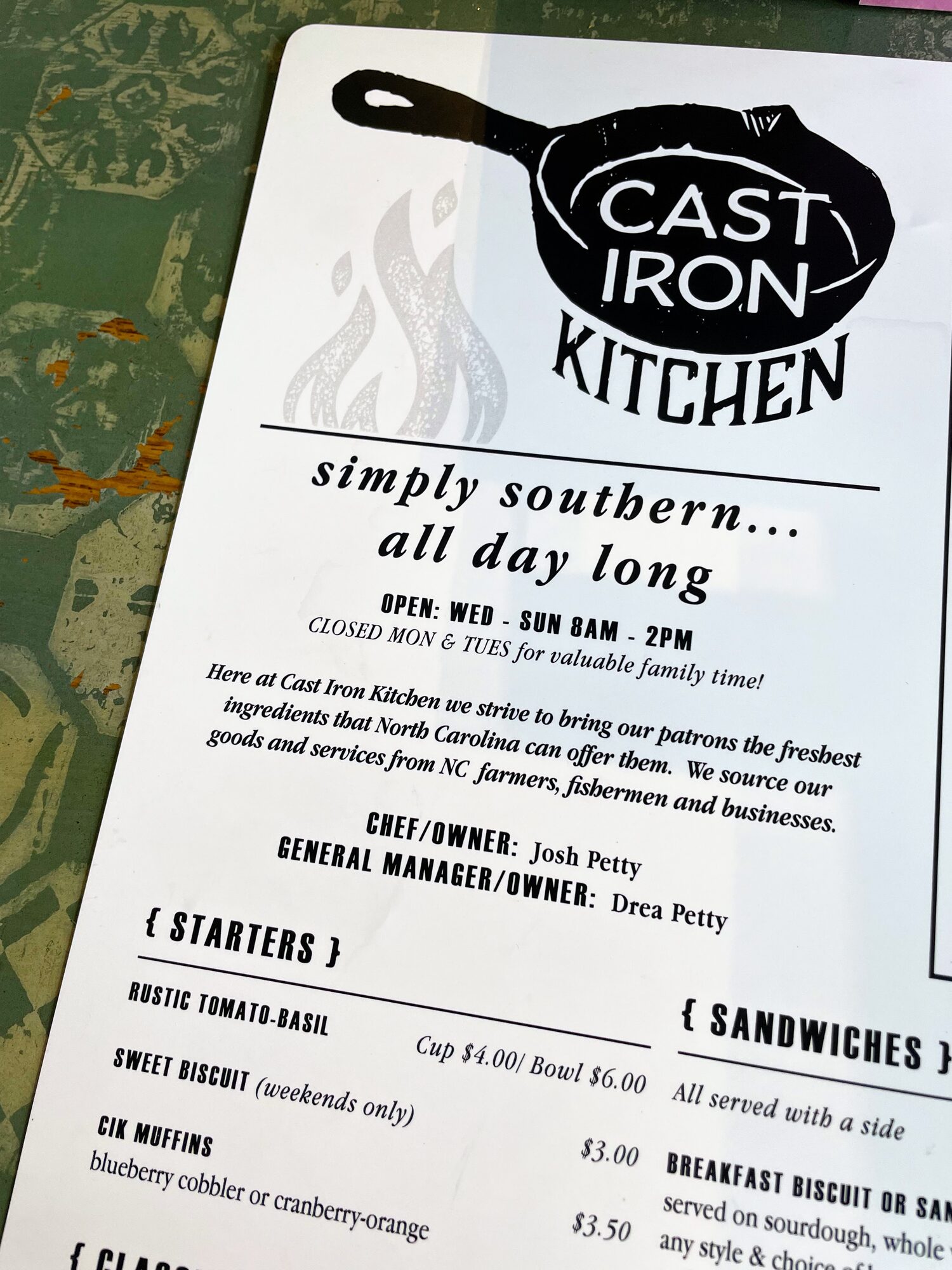A Cast Iron Kitchen menu with the restaurant's skillet logo and the tagline "simply southern... all day long".