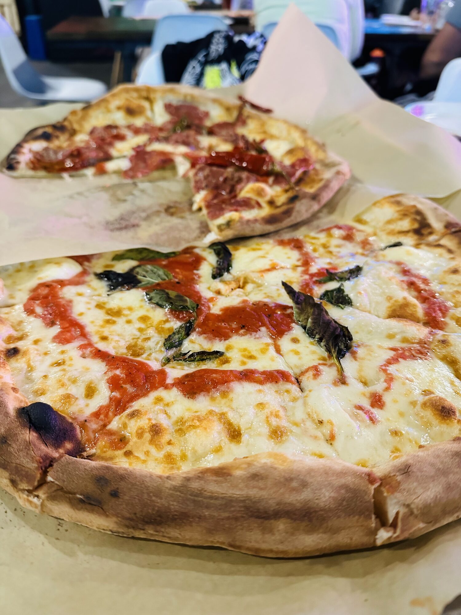 A Neapolitan margherita pizza with a blistered, chewy crust, tomato sauce, mozzarella and fresh basil.