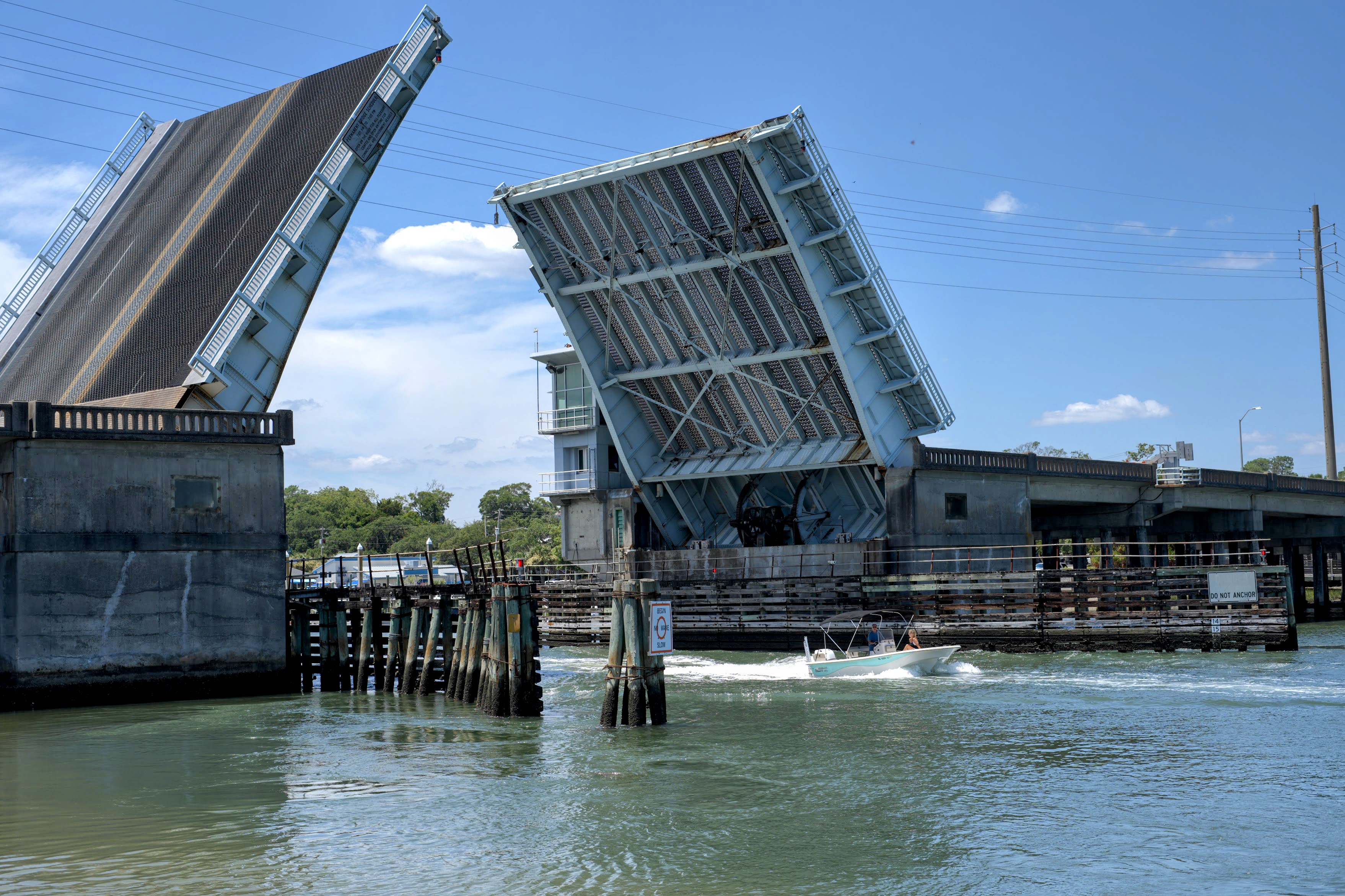 Bascule drawbridge with a boat passing beneath on the Intracoastal Waterway in Wrightsville Beach, NC.