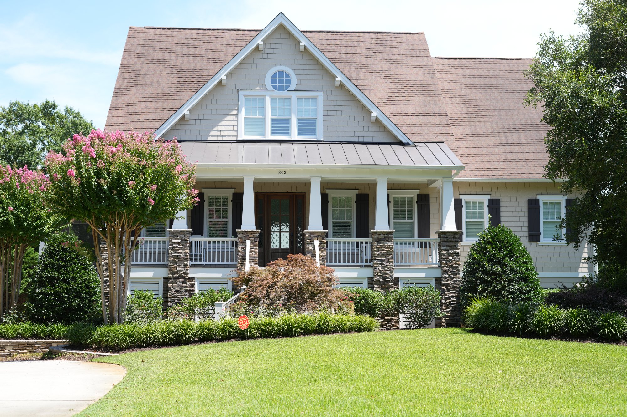 Craftsman-style commercial building at Courtyard at Masonboro with blooming crepe myrtles in Wilmington, NC.